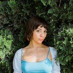 Portrait of a Beautiful Woman in a Blue Top on the Background of a Tree